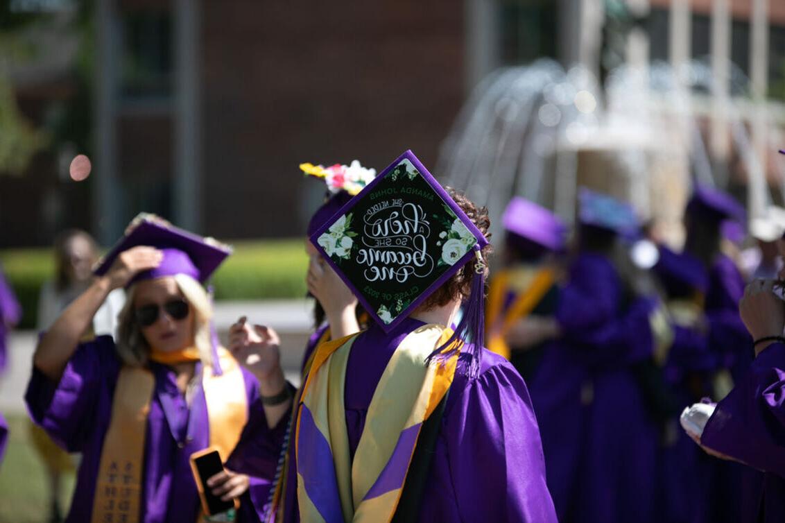 A woman's graduation cap reads: 